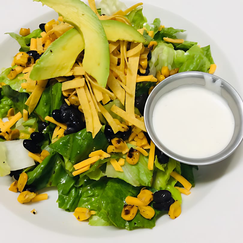 Ishy's Grill American salad with avocado, corn, black beans, cheese, and tortilla strips.